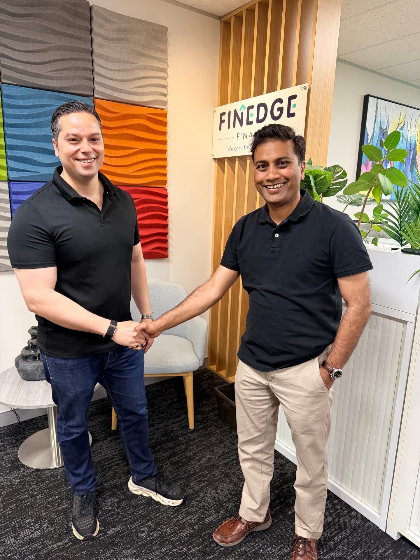 Rahul Bakaya and a FINEDGE Finance representative shaking hands at the Norwest office